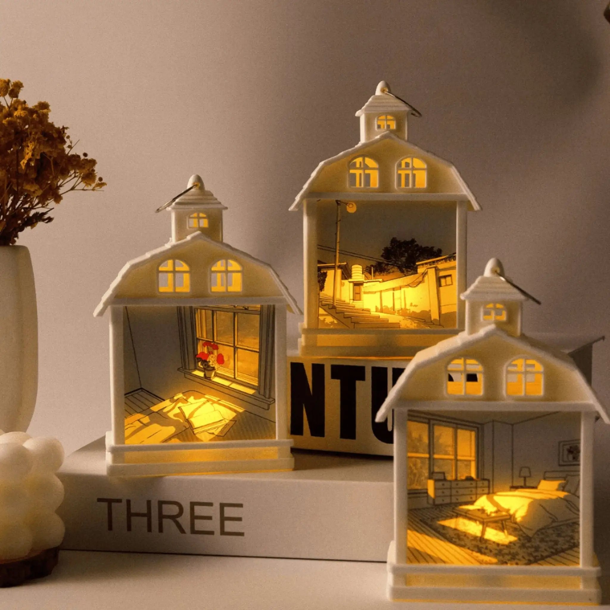 Tableau décoratif à LED représentant une maison avec un éclairage intérieur captivant, idéal pour ajouter de la chaleur à votre décoration moderne.