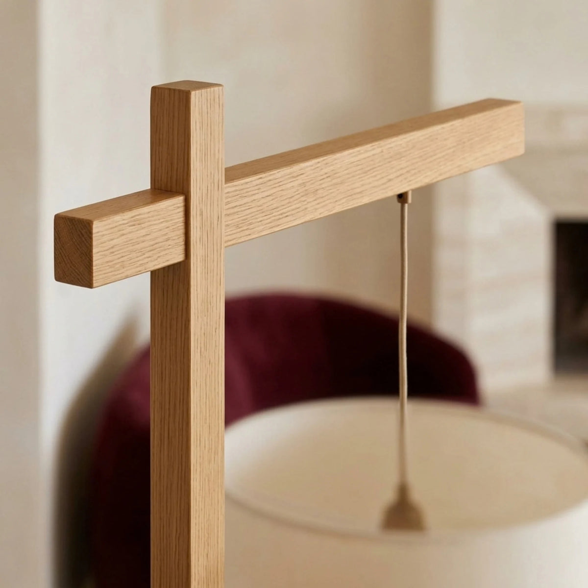 Détail de l'assemblage du bras et du pied en bois naturel, avec le cordon de suspension