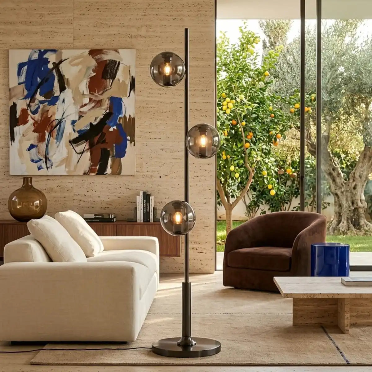 Lampadaire à boules en verre fumé allumé dans un salon moderne ouvert sur un jardin