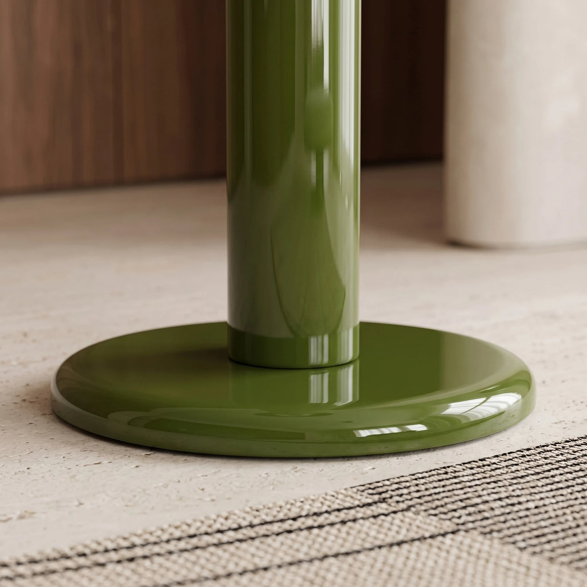 Détail du socle rond laqué vert du lampadaire champignon posé sur un sol en pierre